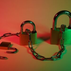 two gray padlock on pink surface